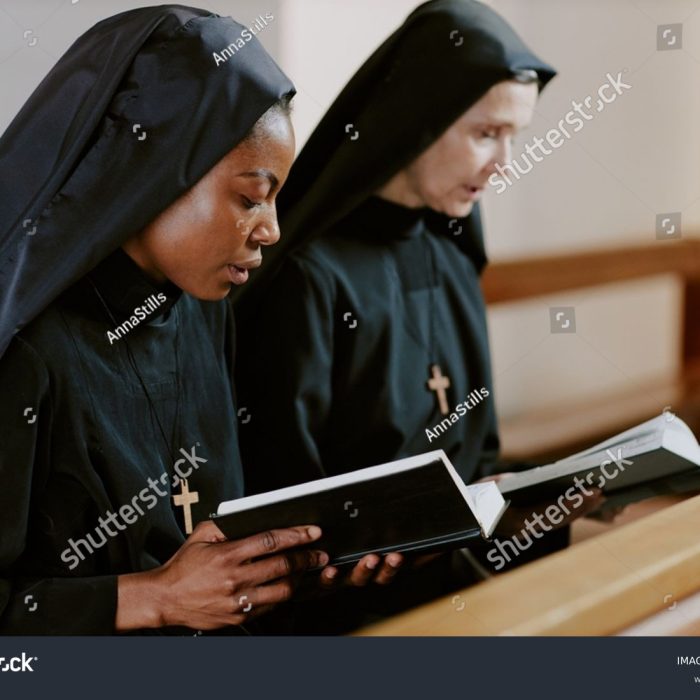 stock-photo-two-ethnically-diverse-catholic-nuns-sitting-on-pew-holding-books-and-saying-prayers-medium-2482988327